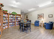 Thumbnail 17 of 66 - A room with a table, chairs, and a bookshelf.
