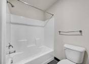 Thumbnail 28 of 51 - a bathroom with a bathtub and a toilet