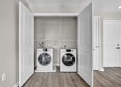 Thumbnail 4 of 18 - A laundry room with two washing machines.