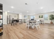 Thumbnail 8 of 35 - a kitchen and dining room with a table and chairs