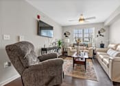 Thumbnail 17 of 33 - a living room with a couch and a chair