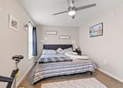 Thumbnail 12 of 12 - a bedroom with a bed and a ceiling fan
