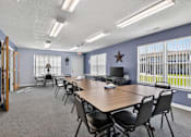 Thumbnail 19 of 49 - A conference room with a long table and chairs.