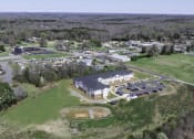 Thumbnail 10 of 22 - an aerial view of a school with a field and a building