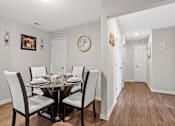 Thumbnail 28 of 33 - a dining room with a table and chairs