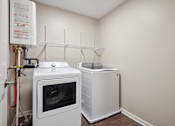 Thumbnail 8 of 38 - a laundry room with a washer and dryer in it