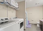 Thumbnail 10 of 12 - a laundry room with a washer and dryer