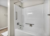 Thumbnail 23 of 51 - a white bathroom with a shower and a tub