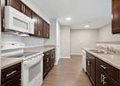 Thumbnail 9 of 38 - a kitchen with white appliances and wooden cabinets