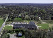 Thumbnail 11 of 22 - an aerial view of a house and a mansion with a green field and trees