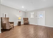 Thumbnail 22 of 33 - a living room with white walls and a wooden floor