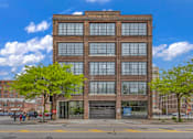 Thumbnail 9 of 51 - a large brick building with a large garage door in front of it