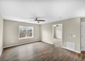Thumbnail 11 of 51 - an empty living room with a ceiling fan and a window
