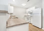 Thumbnail 9 of 26 - a kitchen with a sink and a refrigerator