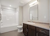 Thumbnail 10 of 38 - a bathroom with a shower toilet sink and mirror