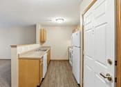 Thumbnail 25 of 66 - A kitchen with white appliances and wooden cabinets.