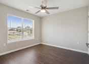 Thumbnail 27 of 38 - an empty bedroom with a ceiling fan and a window