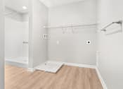 Thumbnail 11 of 26 - a white room with a wood floor and a white closet