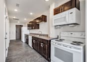 Thumbnail 21 of 51 - a kitchen with white appliances and wooden cabinets