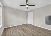 Thumbnail 18 of 51 - an empty living room with a ceiling fan and a door