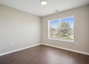 Thumbnail 25 of 38 - an empty room with wood floors and a window