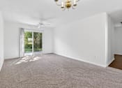 Thumbnail 28 of 49 - A room with a carpeted floor and a ceiling fan.