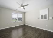 Thumbnail 19 of 22 - an empty living room with a ceiling fan and a window