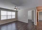 Thumbnail 8 of 32 - a bedroom with hardwood floors and a ceiling fan