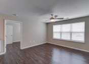 Thumbnail 3 of 32 - an empty room with a ceiling fan and a large window