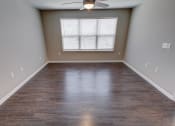 Thumbnail 7 of 32 - an empty room with a ceiling fan and a window