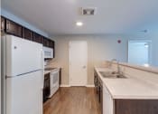 Thumbnail 5 of 32 - a kitchen with a white refrigerator freezer next to a stove top oven
