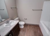 Thumbnail 23 of 32 - a bathroom with a toilet sink and bathtub in a 555 waverly unit