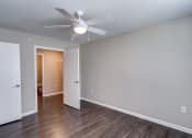 Thumbnail 28 of 32 - a bedroom with a ceiling fan and hardwood floors