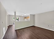 Thumbnail 25 of 51 - A room with wooden floors and white walls.