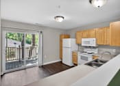 Thumbnail 20 of 51 - A kitchen with wooden cabinets and a white fridge.