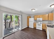 Thumbnail 14 of 51 - A kitchen with white appliances and wooden cabinets.
