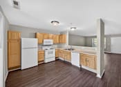 Thumbnail 15 of 51 - A kitchen with white appliances and wooden cabinets.