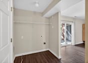 Thumbnail 31 of 51 - A room with a white door, a window, and a wooden floor.
