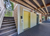Thumbnail 47 of 51 - A yellow door is on the right side of a wooden staircase.