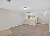 Thumbnail 19 of 48 - A room with a white ceiling and a carpeted floor.