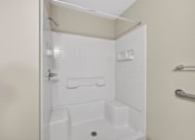 Thumbnail 35 of 48 - A white bathroom with a walk in shower.