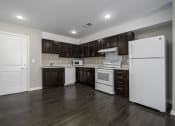 Thumbnail 18 of 22 - a kitchen with white appliances and dark wood cabinets
