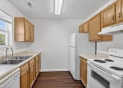 Thumbnail 23 of 49 - A kitchen with wooden cabinets and white appliances.