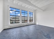 Thumbnail 37 of 51 - an empty room with large windows and a view of a train station