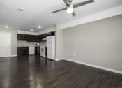 Thumbnail 15 of 22 - a renovated living room and kitchen with a ceiling fan