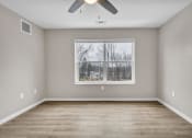 Thumbnail 36 of 51 - an empty room with a window and a ceiling fan