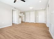 Thumbnail 16 of 26 - an empty living room and kitchen with a wood floor
