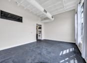 Thumbnail 34 of 51 - an empty room with white walls and a large window