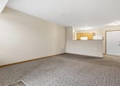 Thumbnail 31 of 66 - Empty room with carpeted floor and white door.
