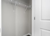 Thumbnail 21 of 22 - a walk in closet with white walls and a white door